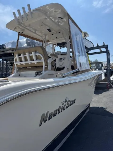 Slide: The Image of 2020 NauticStar 2602 Legacy boat docked under clear blue sky. - 4