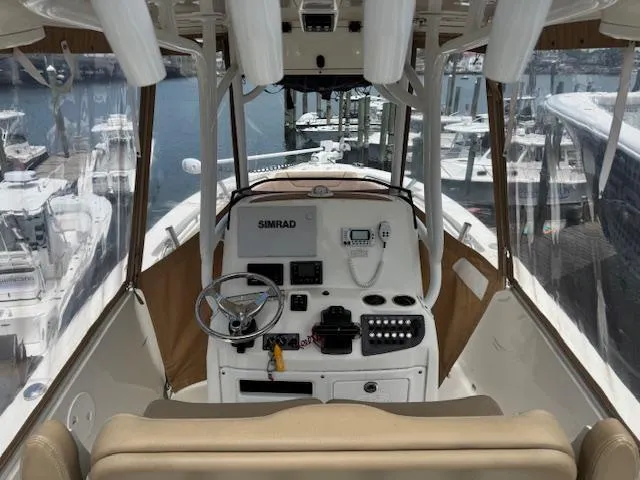 Slide: The Image of 2020 NauticStar 2602 Legacy boat helm with Simrad electronics, docked at marina. - 6