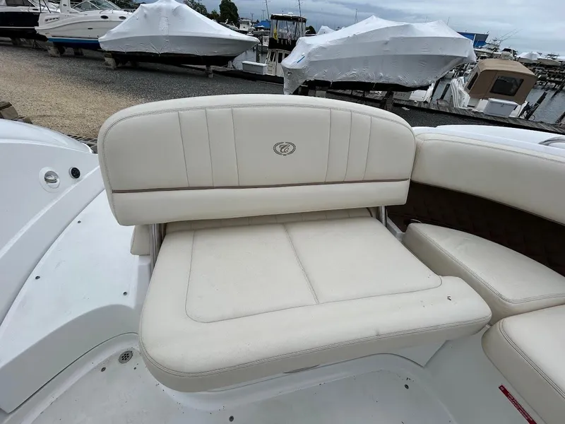 Slide: The Image of 2010 Cobalt 262 boat with white leather seating at a marina. - 15