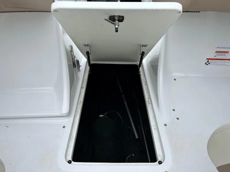 Slide: The Image of Open storage compartment on a 2010 Cobalt 262 boat deck. - 17