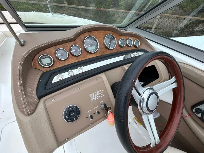 Slide: The Image of Dashboard of a 2010 Cobalt 262 boat with wood accents and steering wheel. - 7
