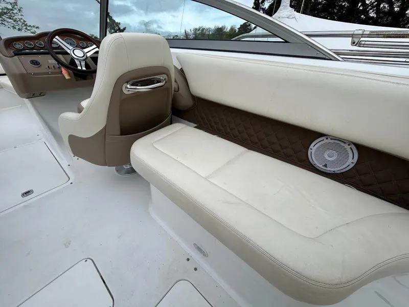 Slide: The Image of Interior of a 2010 Cobalt 262 boat with beige seating and steering wheel. - 8