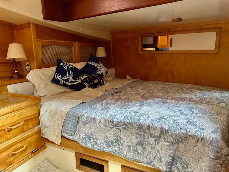 Slide: The Image of Cozy bedroom in 1989 Pilgrim Trawler with nautical-themed decor and wooden furnishings. - 10