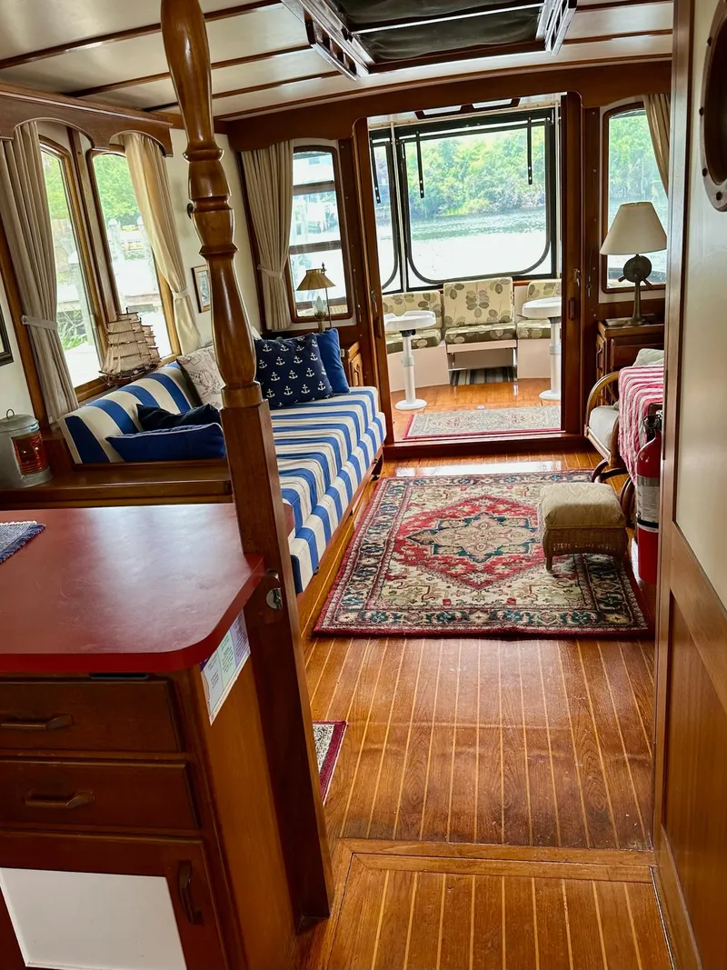 Slide: The Image of Cozy interior of 1989 Pilgrim Trawler with striped sofa, rugs, and large windows. - 24