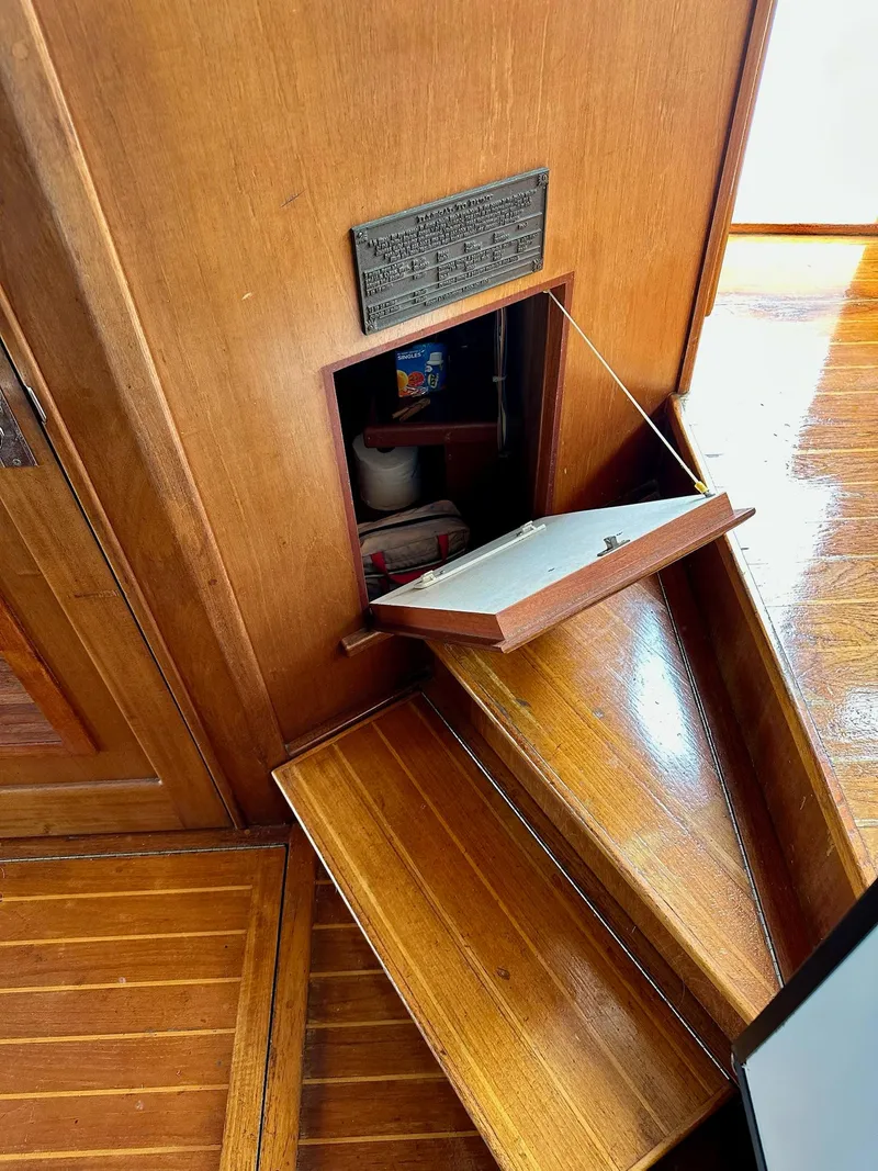 Slide: The Image of Wooden interior of 1989 Pilgrim Trawler with open storage compartment and steps. - 25