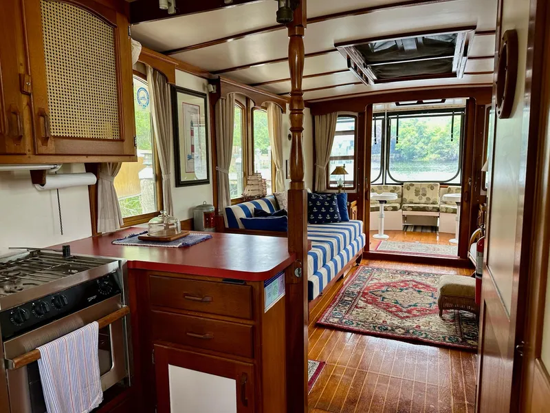 Slide: The Image of Interior of a 1989 Pilgrim Trawler with cozy seating and nautical decor. - 26