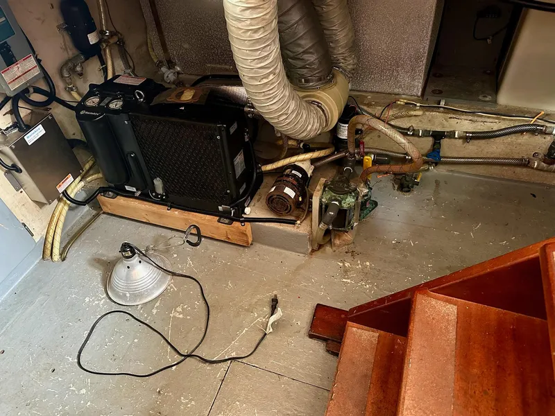 Slide: The Image of Engine room of a 1989 Pilgrim Trawler with mechanical components and wiring. - 28