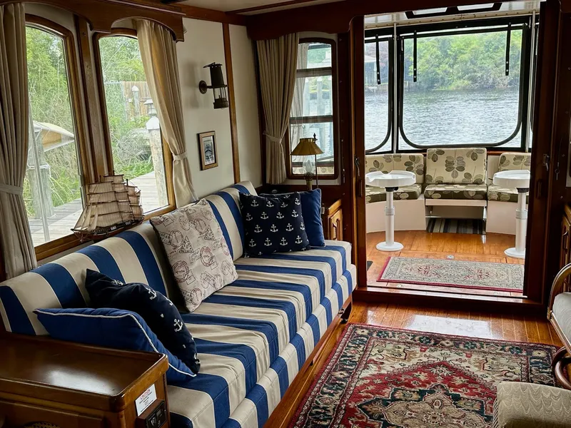 Slide: The Image of Interior of a 1989 Pilgrim Trawler with nautical-themed decor and scenic water view. - 29