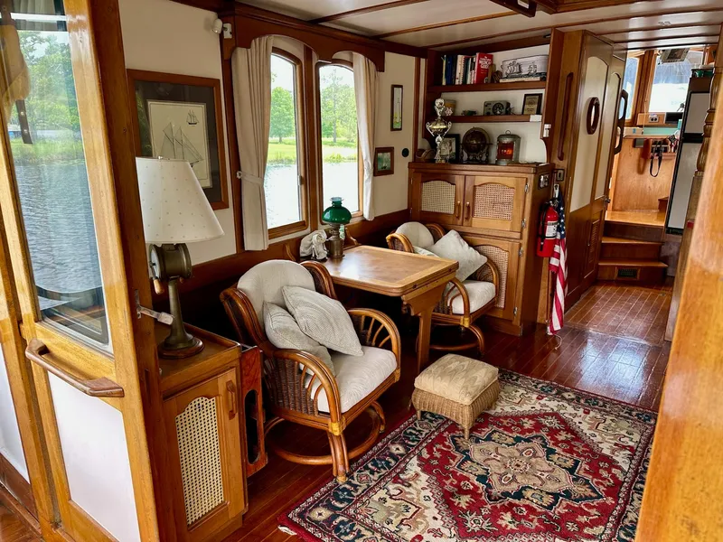 Slide: The Image of Cozy 1989 Pilgrim Trawler interior with wooden decor, seating area, and nautical accents. - 30