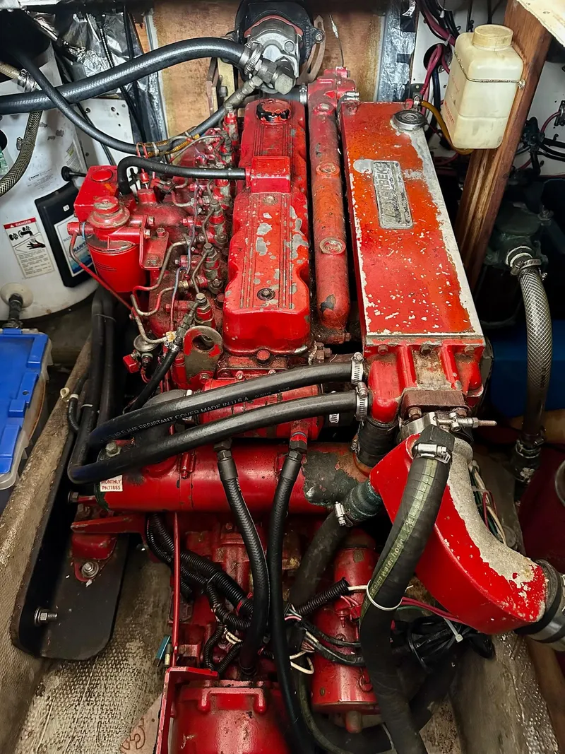 Slide: The Image of Engine of a 1989 Pilgrim Trawler, featuring red components and various hoses. - 37