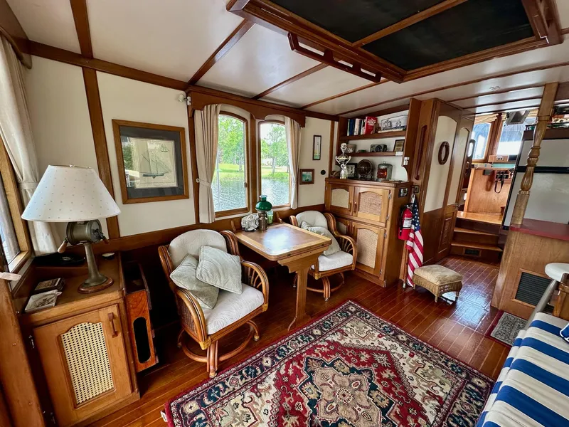 Slide: The Image of Cozy 1989 Pilgrim Trawler interior with wooden decor, seating, and nautical accents. - 41
