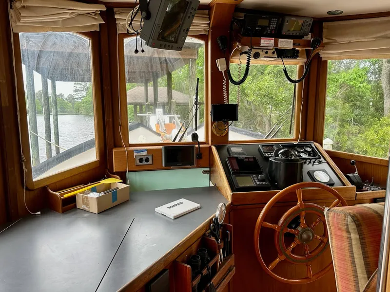 Slide: The Image of Interior of 1989 Pilgrim Trawler boat with steering wheel and navigation equipment. - 6