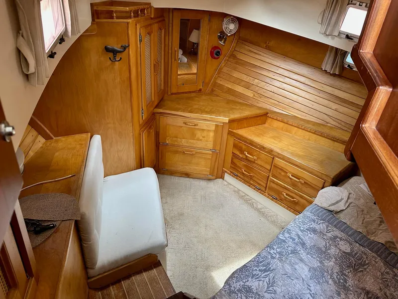 Slide: The Image of 1989 Pilgrim Trawler cabin interior with wooden cabinetry and cozy seating area. - 9