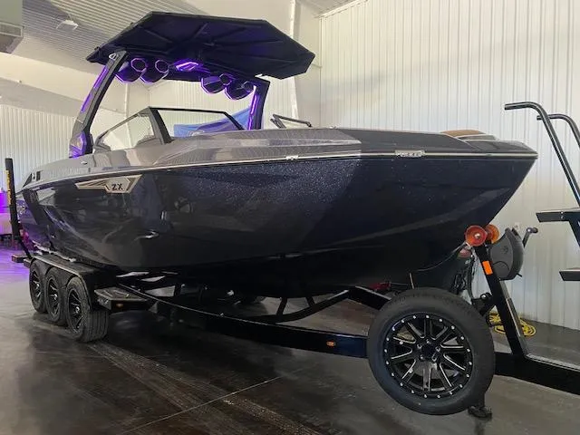 The Image of 2025 Tigé Ultré 25ZX boat on trailer in indoor showroom. - 0