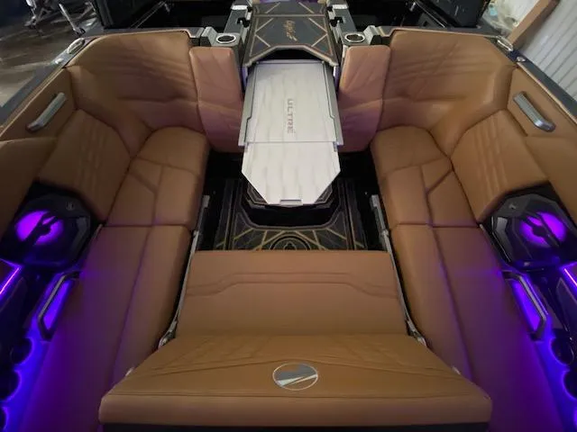 Slide: The Image of Luxurious interior of 2025 Tigé Ultré 25ZX boat with brown leather seating and ambient lighting. - 4