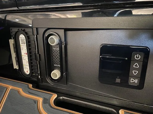 Slide: The Image of Control panel of 2025 Tigé Ultré 25ZX boat, featuring inflate and deflate knobs. - 8