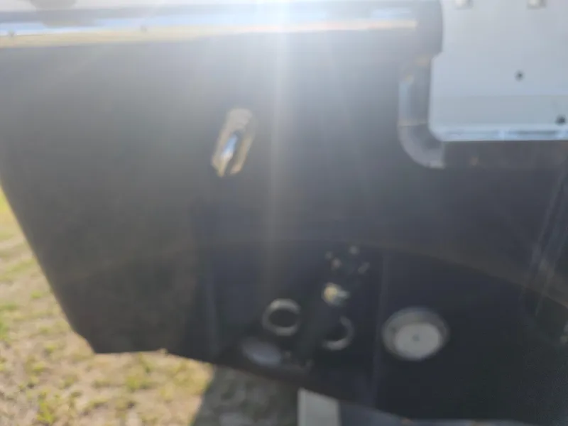 Slide: The Image of Blurry image of a 2010 Triton 301 CC boat detail with sunlight glare. - 10