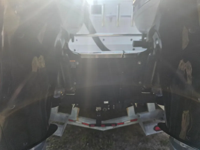 Slide: The Image of Rear view of a 2010 Triton 301 CC boat with dual outboard motors. - 11