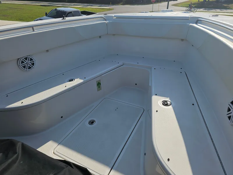 Slide: The Image of 2010 Triton 301 CC boat interior with spacious seating and storage compartments. - 14