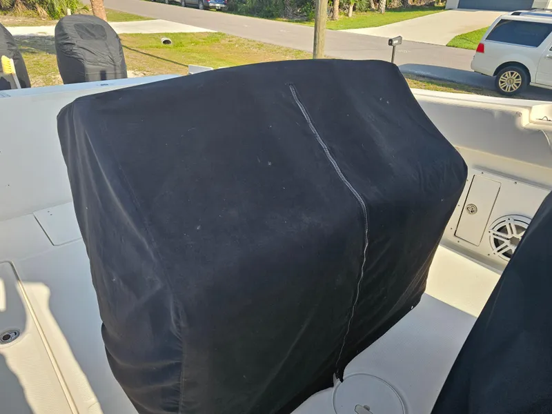 Slide: The Image of Covered console on a 2010 Triton 301 CC boat, parked outdoors. - 15