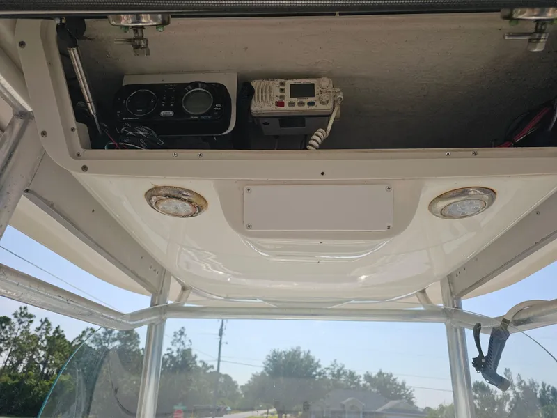 Slide: The Image of 2010 Triton 301 CC boat console with radio and communication equipment. - 19