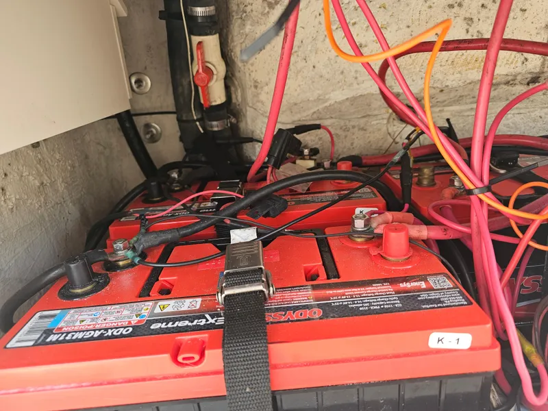 Slide: The Image of Battery compartment of a 2010 Triton 301 CC boat with red and black wiring. - 23