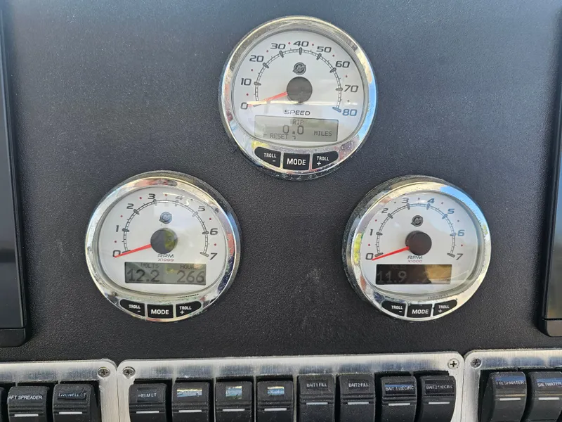 Slide: The Image of Dashboard of a 2010 Triton 301 CC boat with speed and RPM gauges. - 28