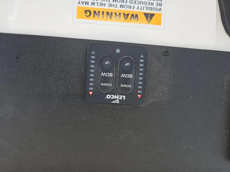 Slide: The Image of Lenco trim tab control panel on 2010 Triton 301 CC boat dashboard. - 30