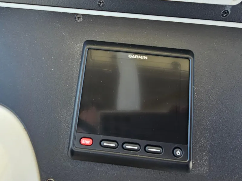 Slide: The Image of Garmin display on 2010 Triton 301 CC boat dashboard, featuring control buttons. - 32