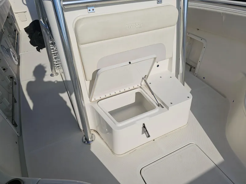 Slide: The Image of 2010 Triton 301 CC boat interior with open storage compartment and seating. - 33