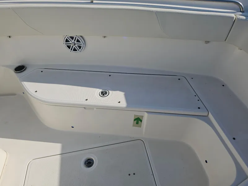 Slide: The Image of 2010 Triton 301 CC boat interior with storage compartments and speaker. - 34