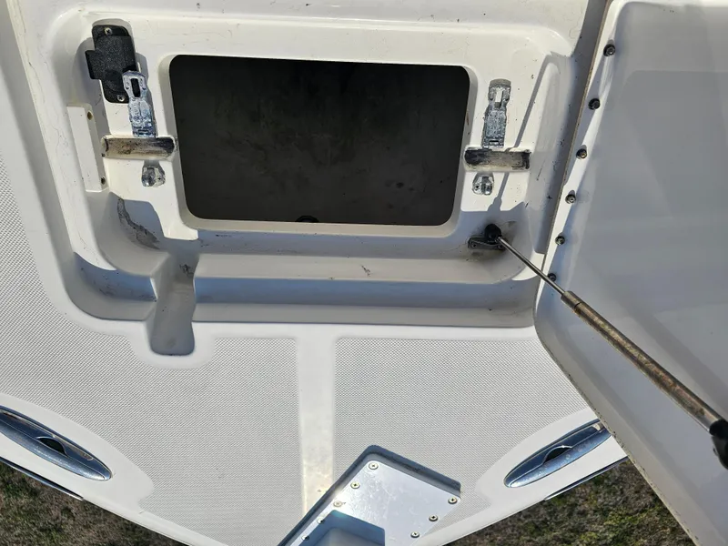 Slide: The Image of Open storage compartment on 2010 Triton 301 CC boat deck. - 39