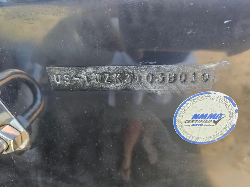 Slide: The Image of 2010 Triton 301 CC boat hull identification number and NMMA certification sticker. - 4