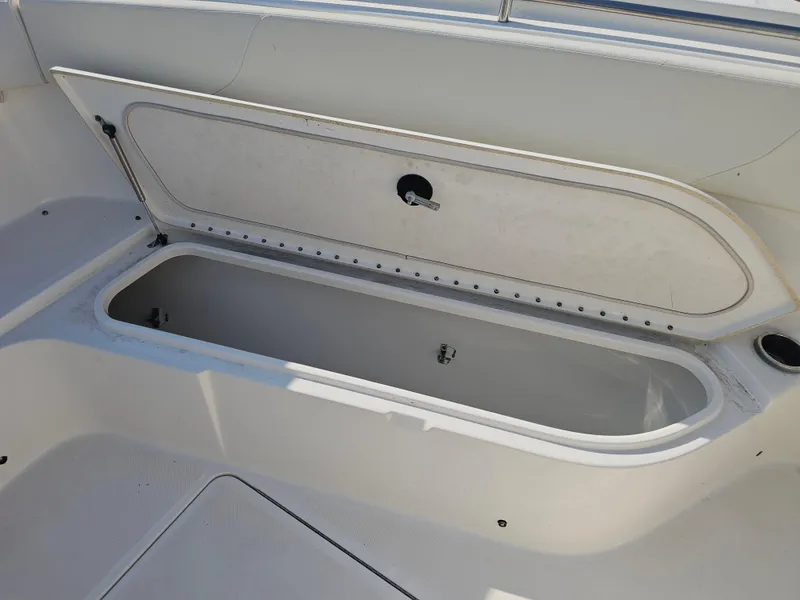 Slide: The Image of Open storage compartment on 2010 Triton 301 CC boat, showcasing interior space. - 40
