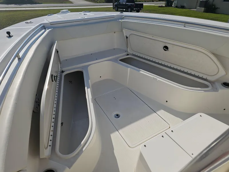 Slide: The Image of 2010 Triton 301 CC boat interior with open storage compartments. - 41