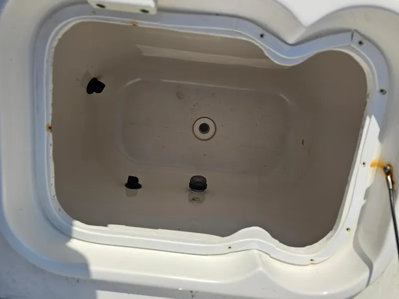 Slide: The Image of Open storage compartment in 2010 Triton 301 CC boat, showing interior details. - 45