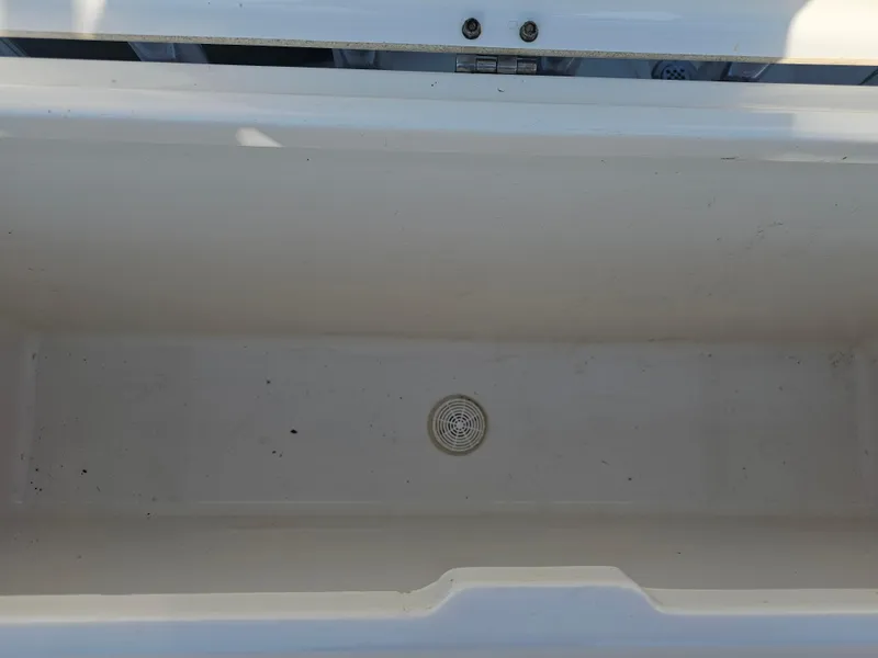 Slide: The Image of Empty storage compartment on a 2010 Triton 301 CC boat. - 48