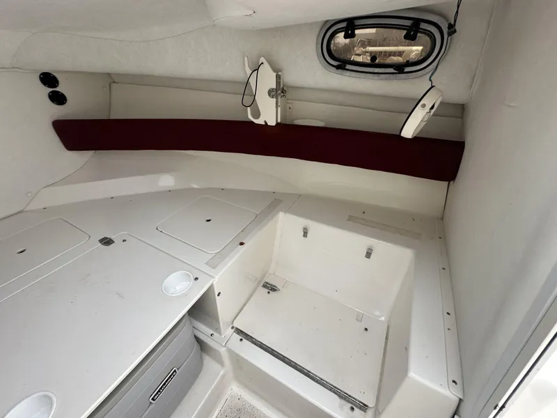 Slide: The Image of Interior cabin of a 1998 Boston Whaler 21 Conquest boat, featuring storage compartments. - 13