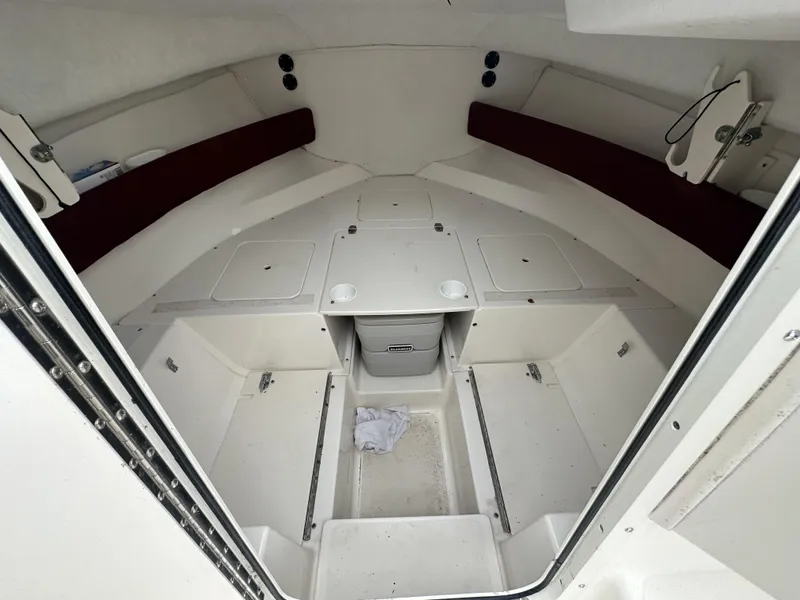 Slide: The Image of 1998 Boston Whaler 21 Conquest cabin interior with storage compartments and seating. - 6
