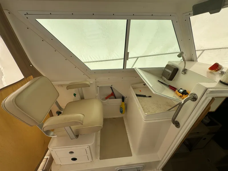 Slide: The Image of 2003 Albin 28 TE Flush Deck interior with helm seat and control panel. - 13