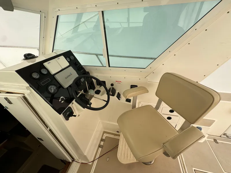 Slide: The Image of Helm of 2003 Albin 28 TE Flush Deck with steering wheel and beige captain's chair. - 14