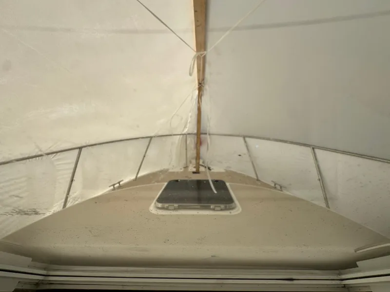 Slide: The Image of 2003 Albin 28 TE Flush Deck boat under cover, showing bow and railing. - 18