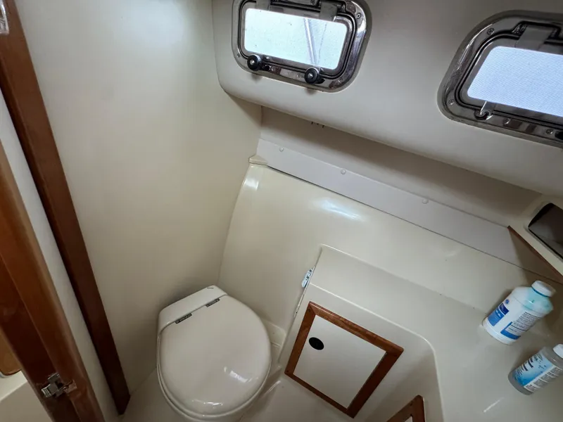 Slide: The Image of 2003 Albin 28 TE Flush Deck boat bathroom with toilet and storage cabinet. - 26
