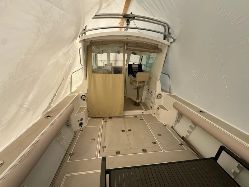 Slide: The Image of 2003 Albin 28 TE Flush Deck boat interior with seating and helm station. - 8
