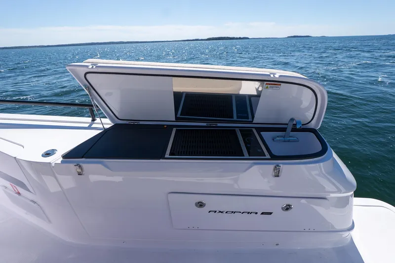 Slide: The Image of Open deck kitchen on 2025 Axopar 45 boat, featuring grill and sink. - 24