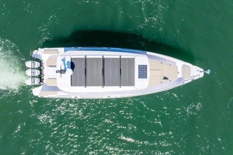 Slide: The Image of Aerial view of 2025 Axopar 45 boat cruising on green water. - 4