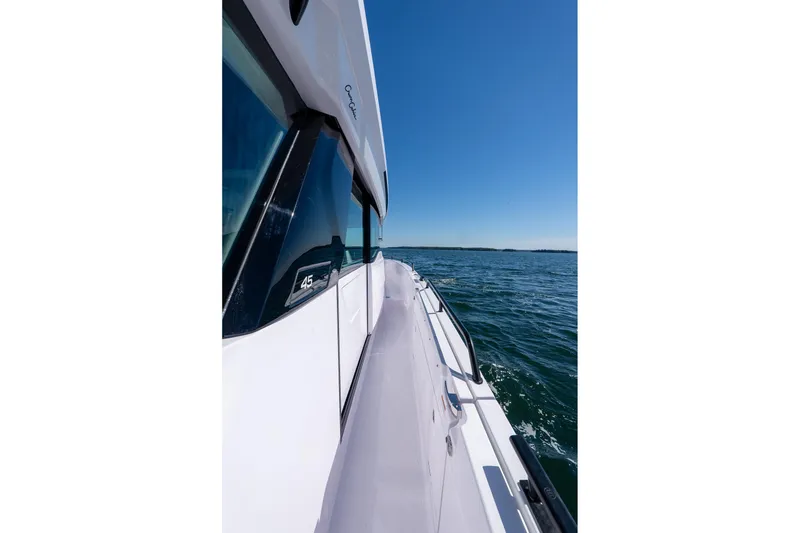 Slide: The Image of Interior of 2025 Axopar 45 boat with panoramic windows and modern seating. - 48