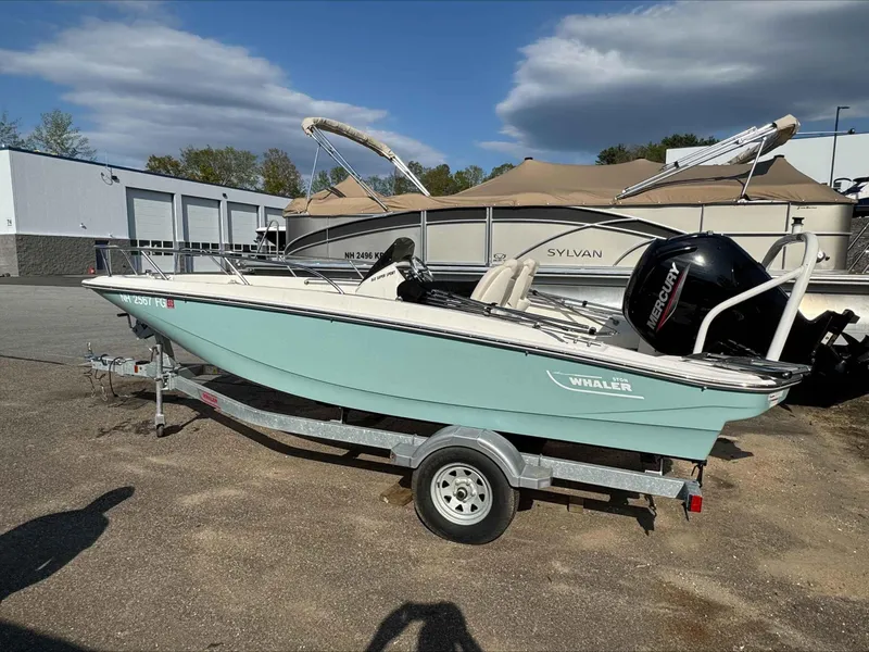 Slide: The Image of 2020 Boston Whaler 160 Sport boat on trailer, parked outdoors. - 2