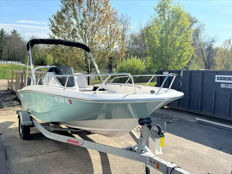 Slide: The Image of 2020 Boston Whaler 160 Sport boat on trailer, parked outdoors in sunny setting. - 3