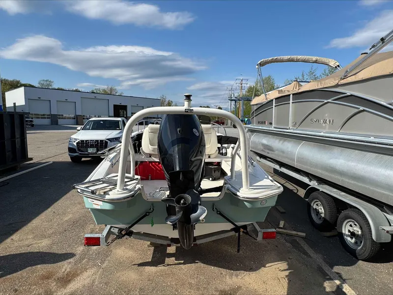 Slide: The Image of Boston Whaler 160 Sport 2020 boat on trailer, parked outdoors under clear sky. - 4